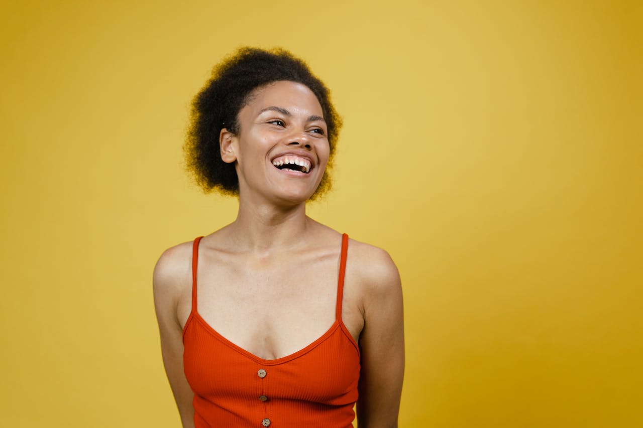 Woman in Orange Tank Top Smiling